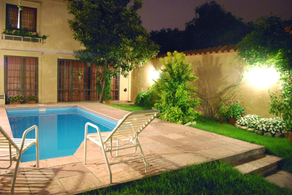 a swimming pool in a yard at night at Hotel del Antiguo Convento in Salta