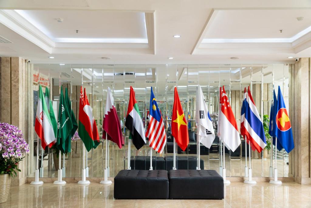 A polished lobby display of international flags backed by mirrored walls.