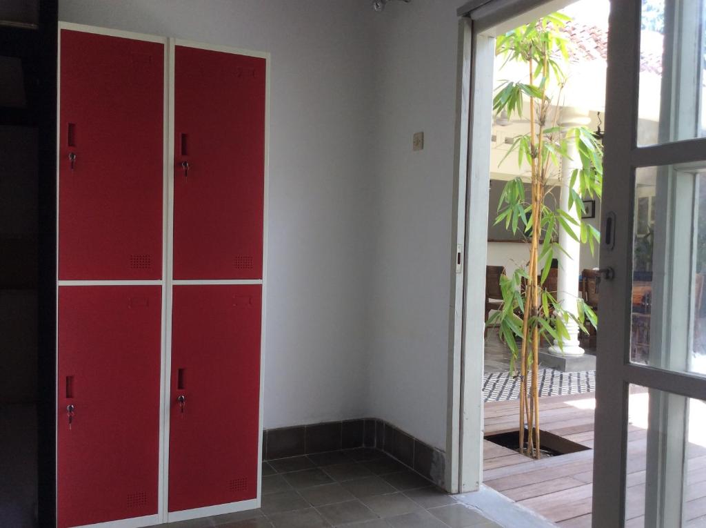 a room with red cabinets and a sliding glass door at The Patio Yogya in Yogyakarta