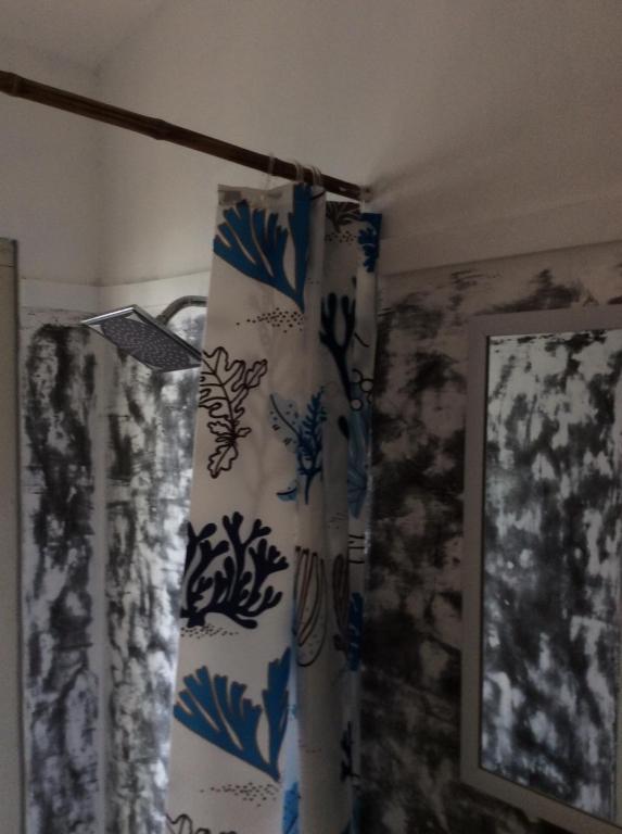 a blue and white curtain in a room with a lamp at The Patio Yogya in Yogyakarta