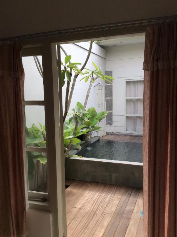 an open door to a pool in a room at The Patio Yogya in Yogyakarta