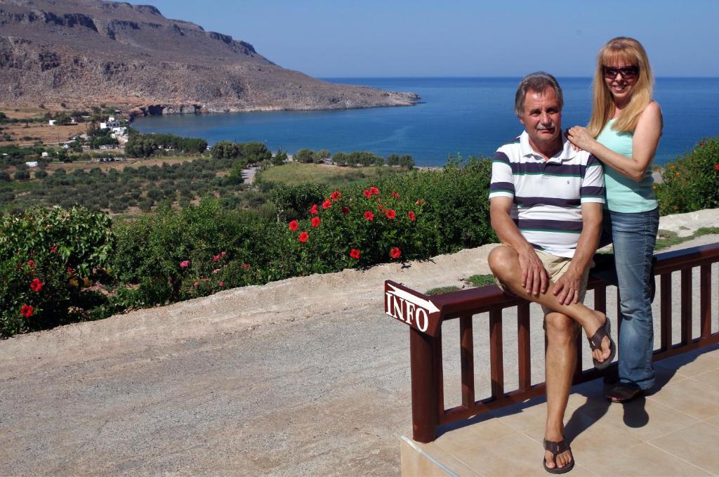 a man and a woman sitting on a bench at Kato Zakros Palace Apartments in Kato Zakros