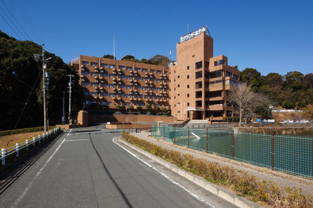 an empty road in front of a large building at Toyokawa Grand Hotel in Toyokawa