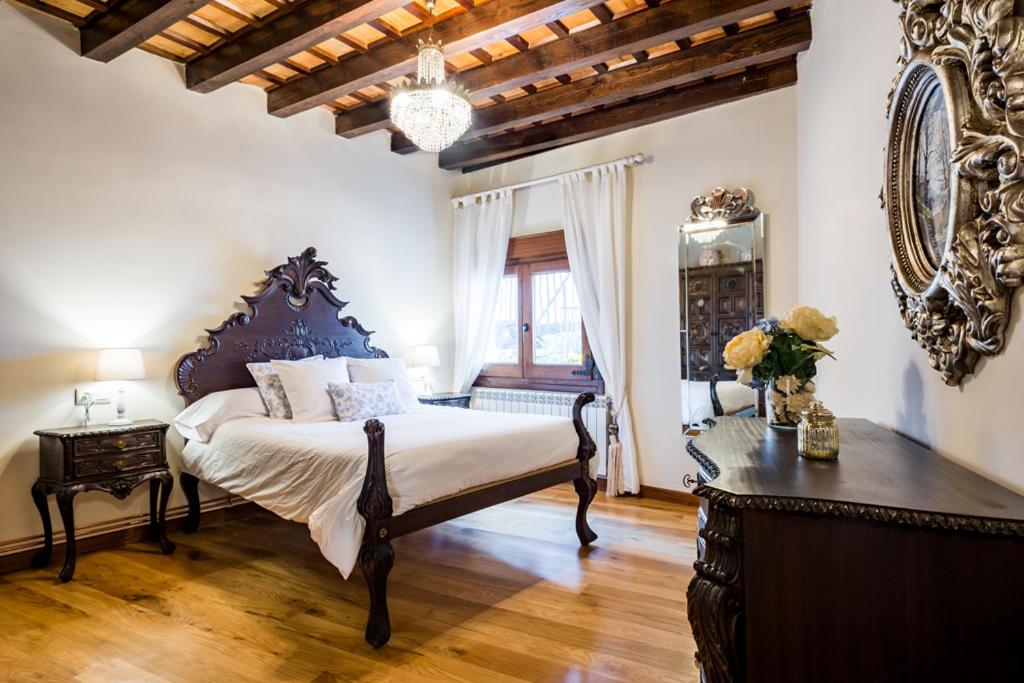 a bedroom with a bed and a table and a mirror at El Aserradero in La Alberca