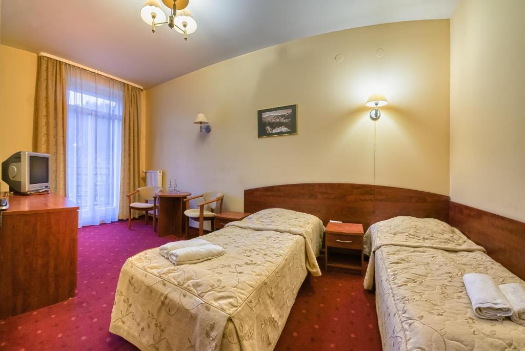 Posteľ alebo postele v izbe v ubytovaní Nowy Dom Zdrojowy
