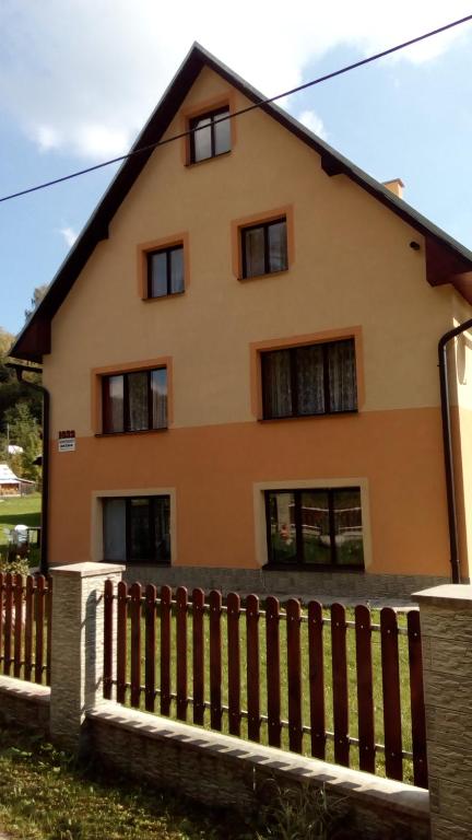 a house with a fence in front of it at Apartmány Božka in Terchová