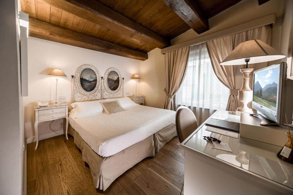 Postel nebo postele na pokoji v ubytování Hotel & Residenza 100 Torri