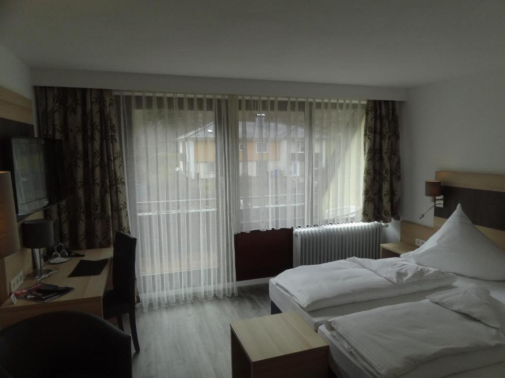 Postel nebo postele na pokoji v ubytování Hotel Wasserfall
