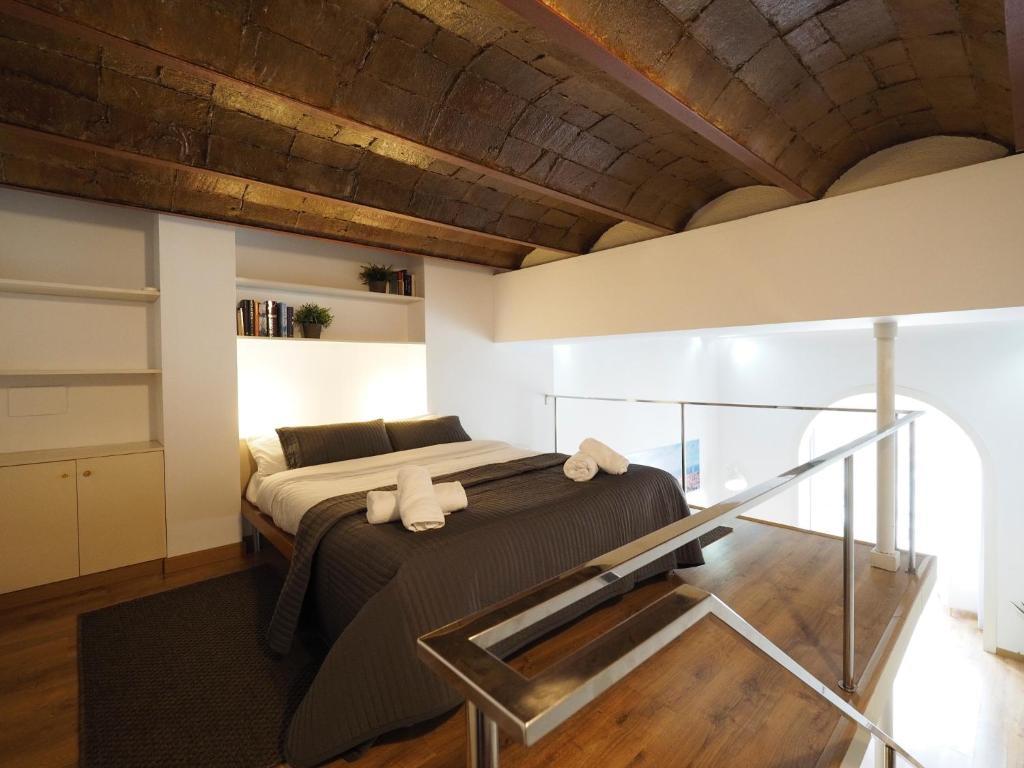 a bedroom with a large bed with a wooden ceiling at Paseo de Gracia Design in Barcelona