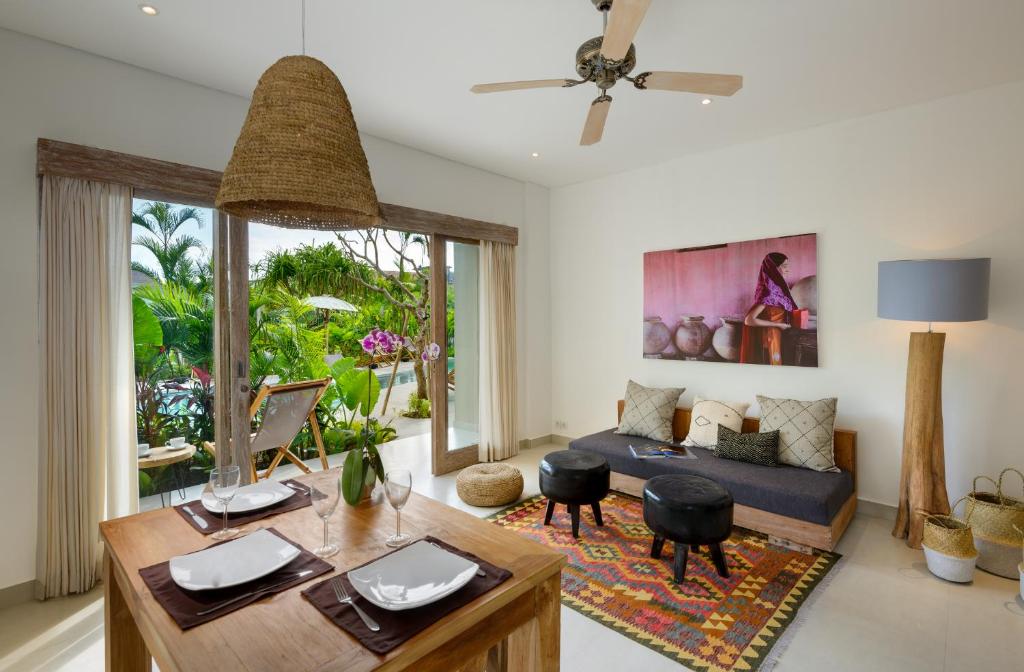 a living room with a couch and a table at Canggu Beach Apartments in Canggu