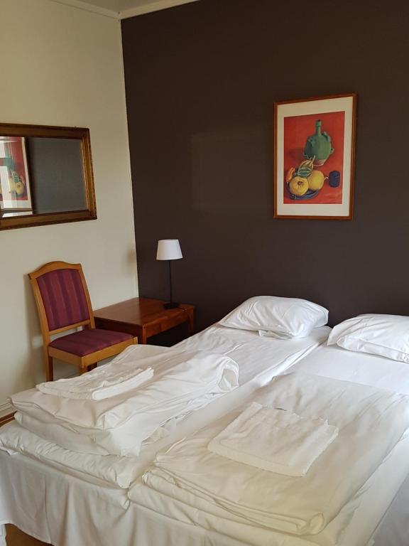 Postel nebo postele na pokoji v ubytování Grand Hotel Hønefoss