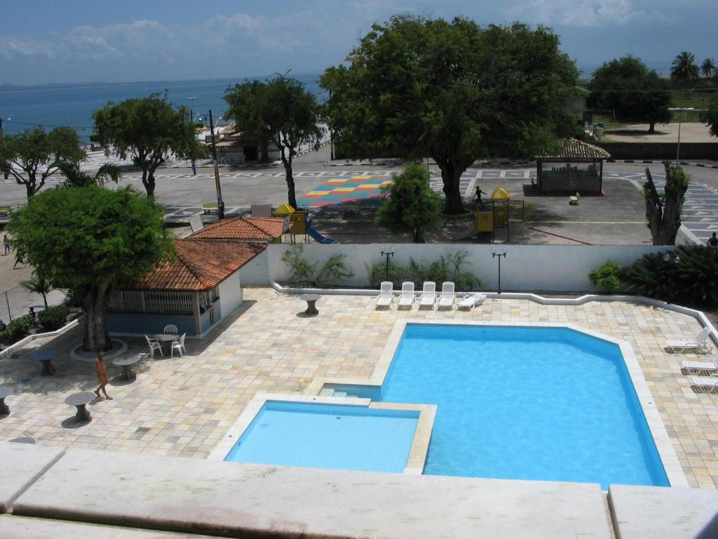 a view of a swimming pool from a building at Salinas Praia Hotel in Salinas da Margarida