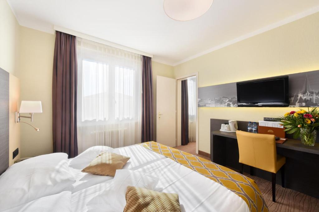 Postel nebo postele na pokoji v ubytování Hôtel Bellerive