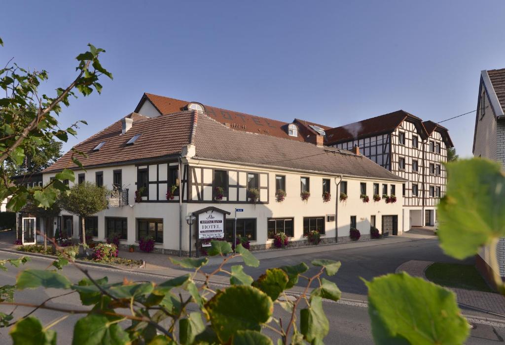 a large white building on the side of a street at Adler Golf-& Tagungshotel in Harth - Pöllnitz
