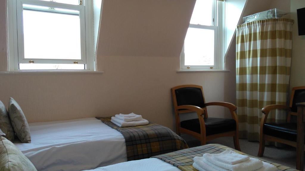 Postel nebo postele na pokoji v ubytování Swiss Court Guest House