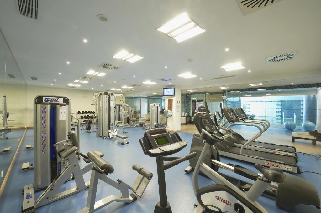 a gym with several treadmills and cardio machines at Grande Real Santa Eulalia Resort & Hotel Spa in Albufeira