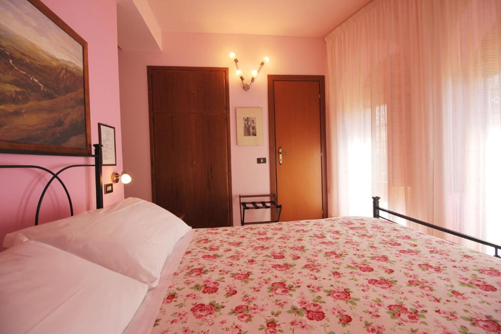 Postel nebo postele na pokoji v ubytování Hotel Pallotta