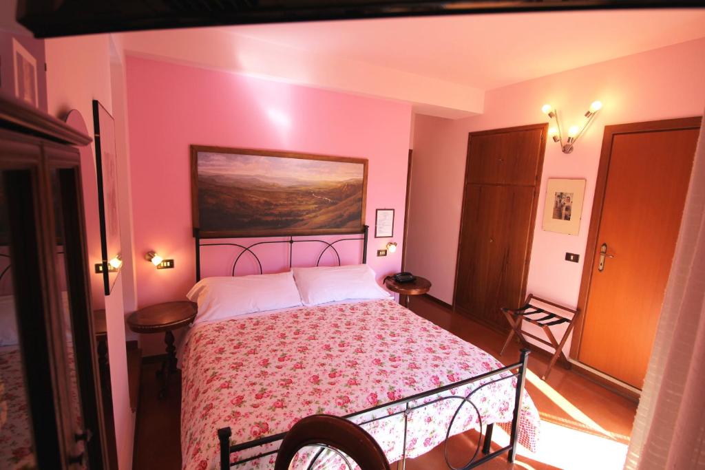 Postel nebo postele na pokoji v ubytování Hotel Pallotta