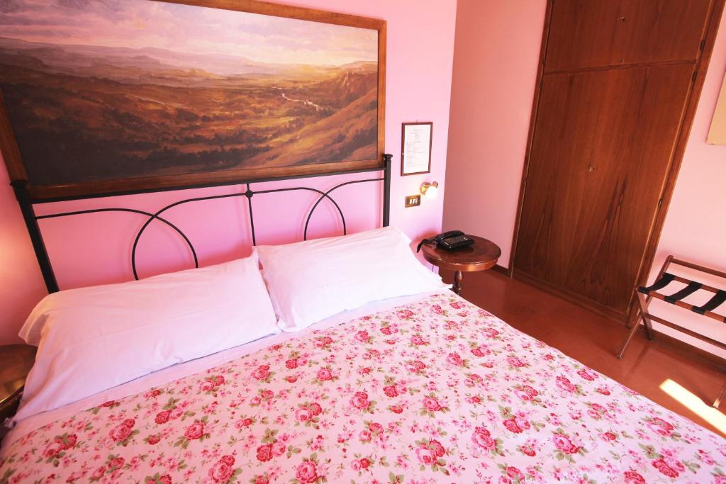 Postel nebo postele na pokoji v ubytování Hotel Pallotta