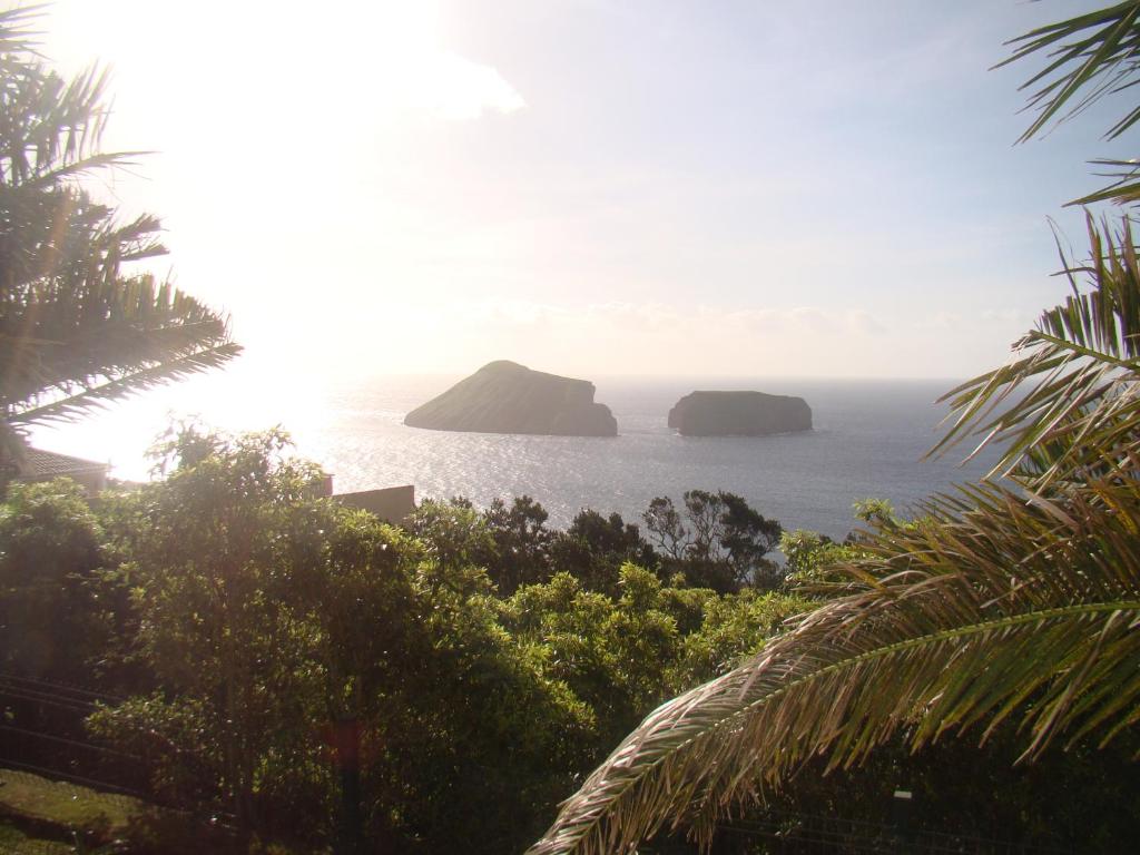 a view of the ocean with rocks in the water at Casa das Merces in Angra do Heroísmo