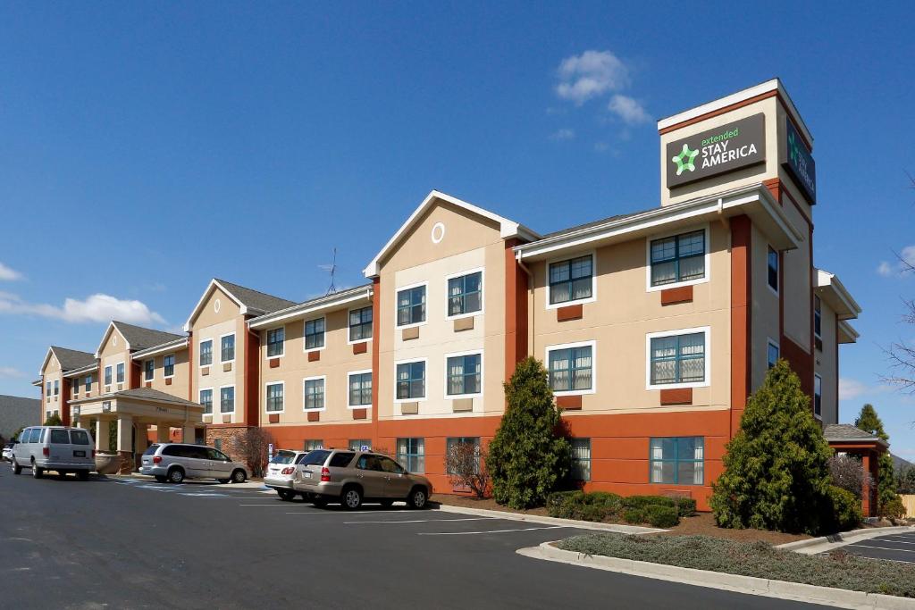 a hotel building with cars parked in a parking lot at Extended Stay America Suites - Indianapolis - Castleton in Fishers