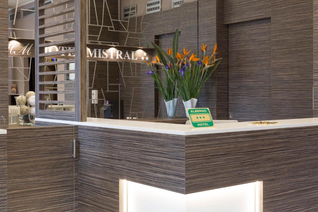 a store counter with a vase of flowers on it at Hotel Mistral in Milan