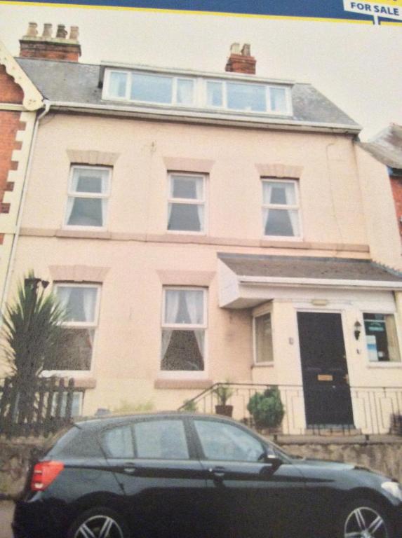 a black car parked in front of a house at Alexander B&B in Hereford