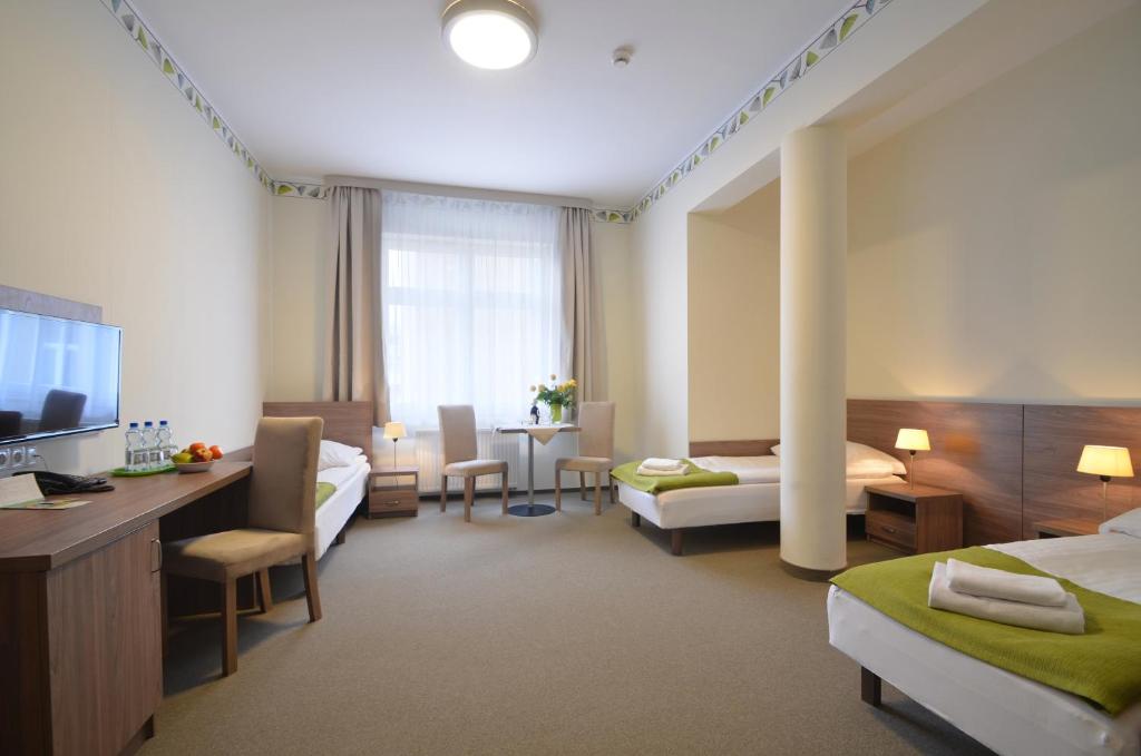 Postel nebo postele na pokoji v ubytování Hotel Zorza