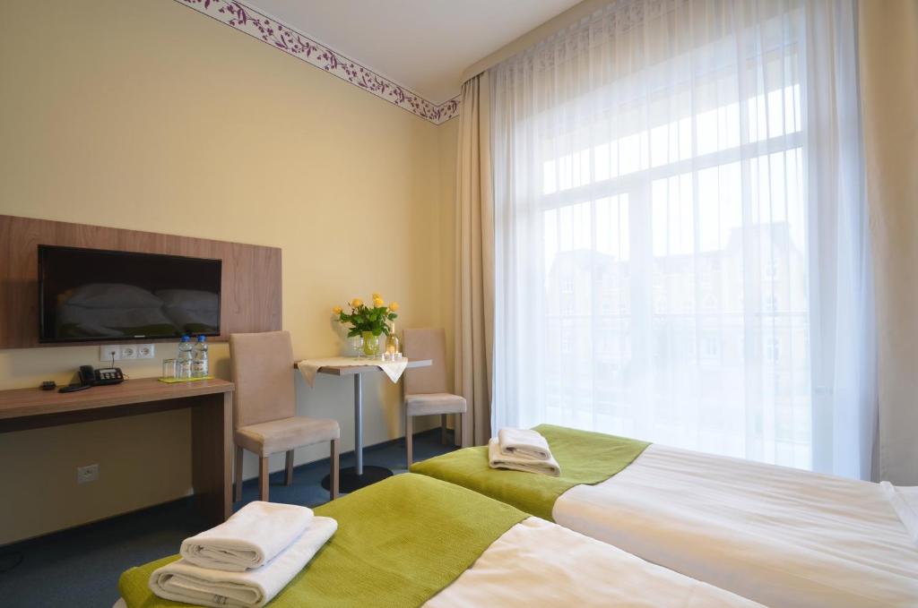 Postel nebo postele na pokoji v ubytování Hotel Zorza