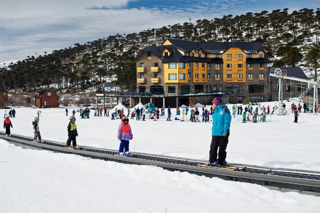 a group of people on skis in the snow at Grand Hotel Caviahue in Caviahue