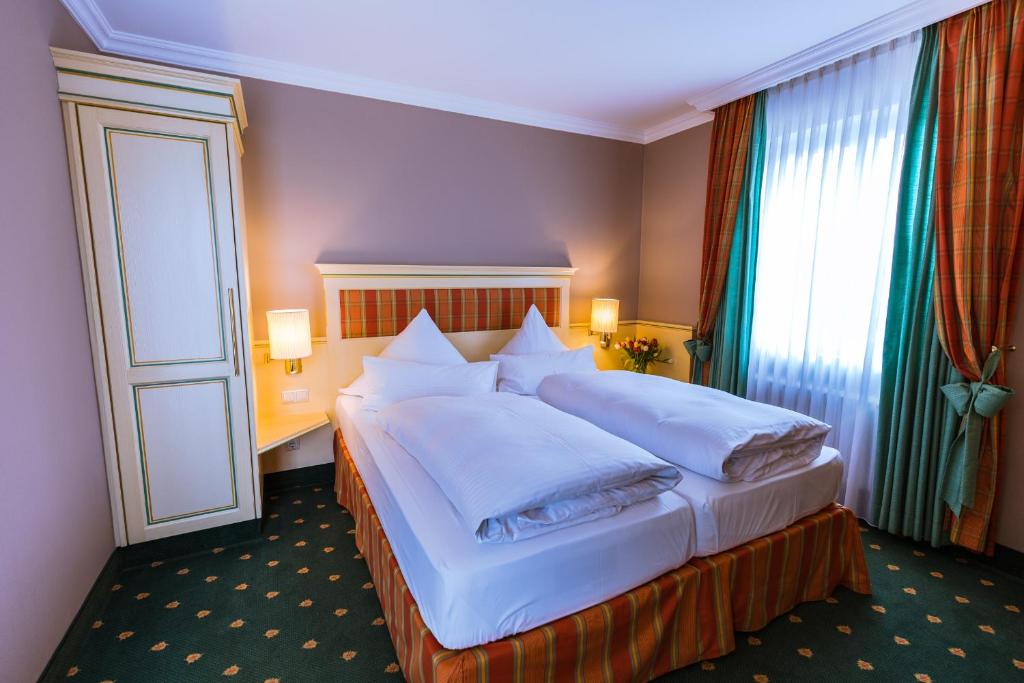 Postel nebo postele na pokoji v ubytování Hotel Kandler