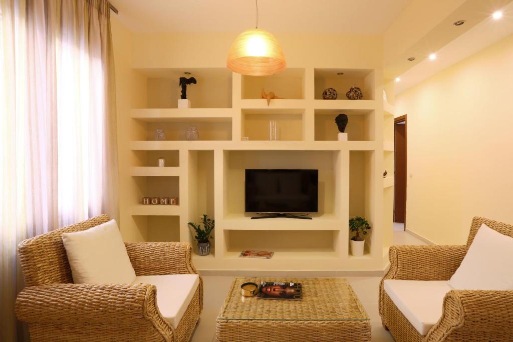 a living room with two chairs and a television at Cashel House in Corfu