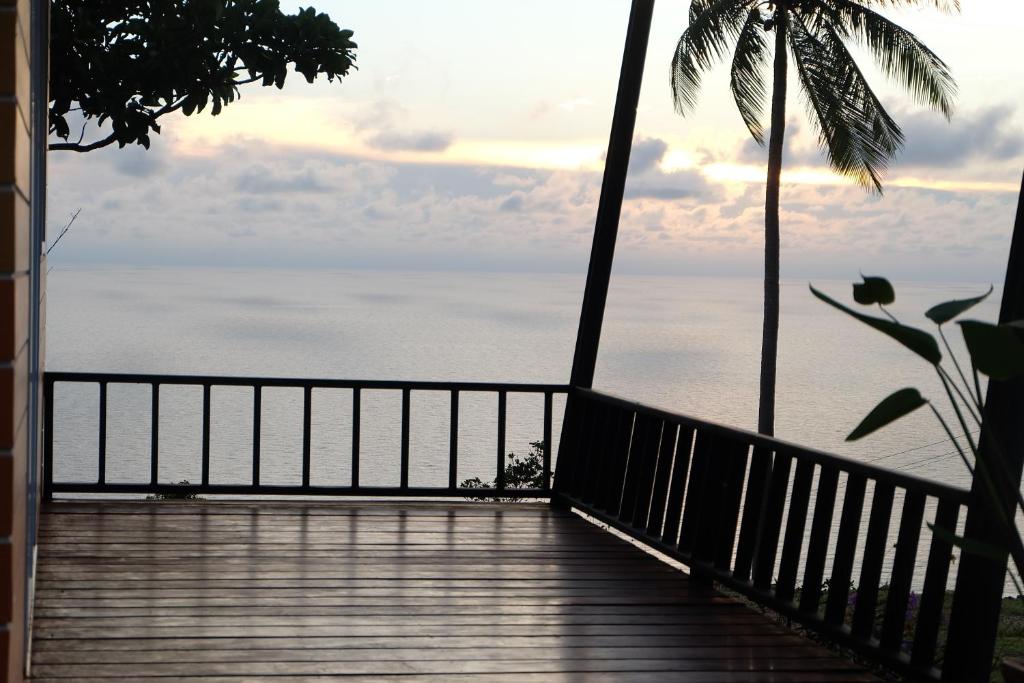 a wooden walkway with a view of the ocean at Love Koh Tao Villa in Koh Tao