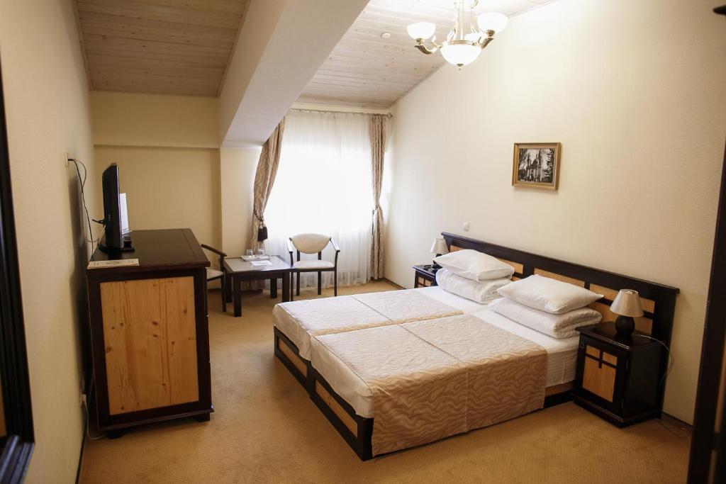 Postel nebo postele na pokoji v ubytování Georg Palace Hotel