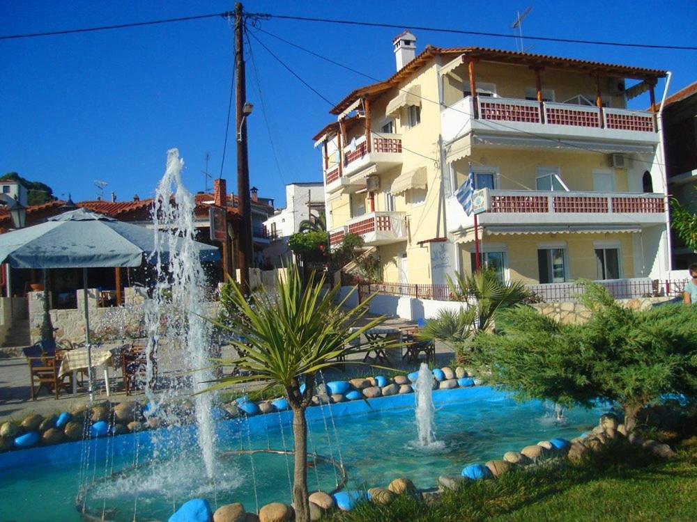 a water fountain in front of a building at Peristerianos apartments in Nea Skioni