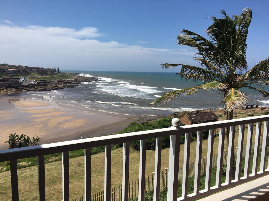 a view of the beach from a balcony at Laguna la crete unit X in Uvongo Beach