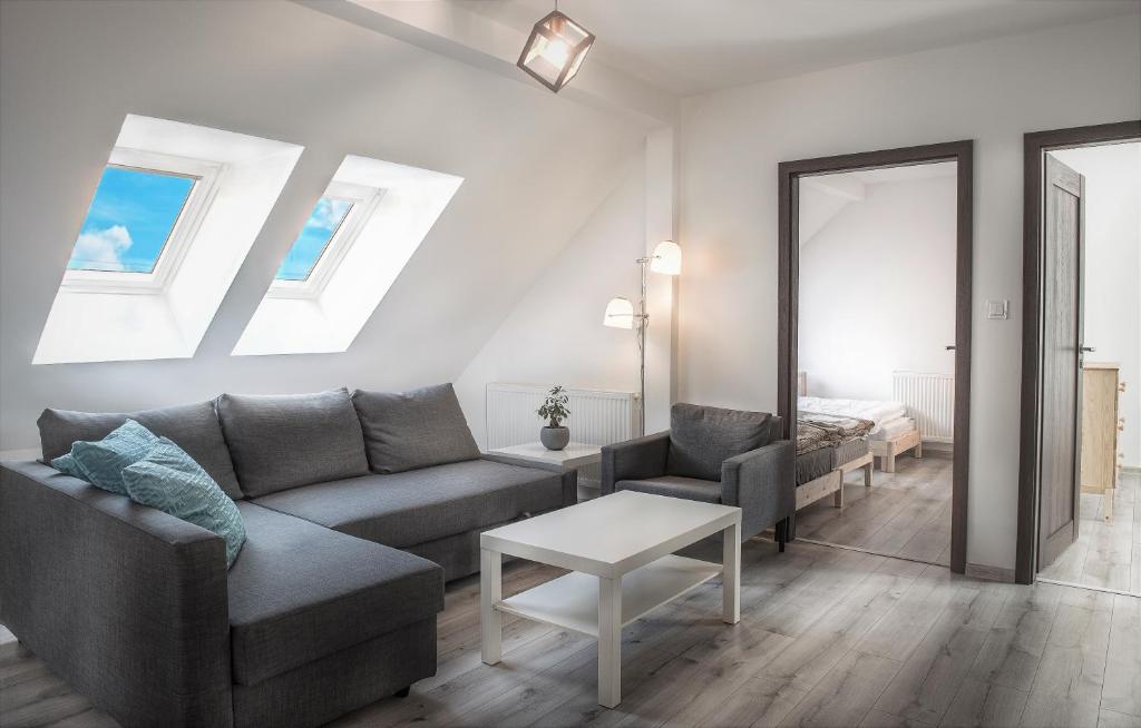 a living room with a couch and a table at Garden apartments in Prešov