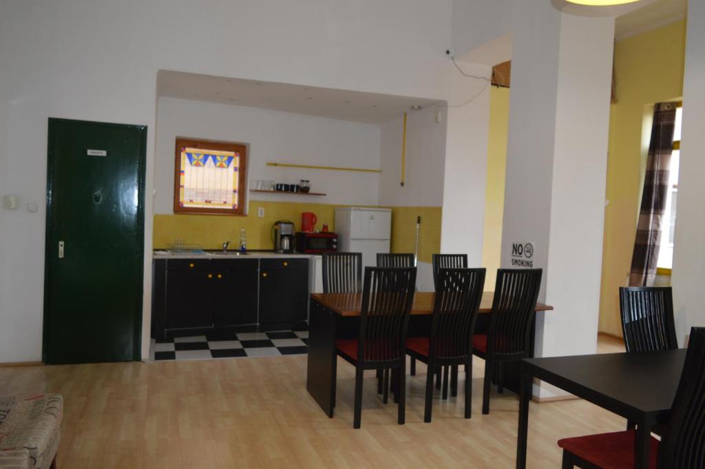 a kitchen and dining room with a table and chairs at Hostel 66 in Szeged