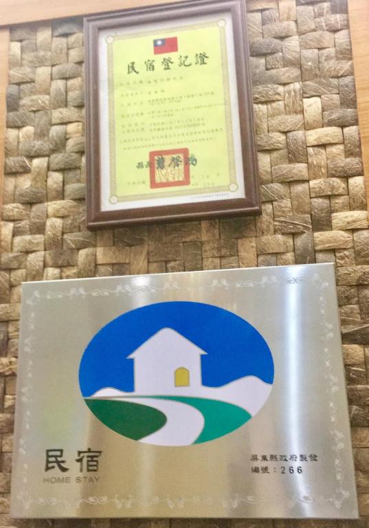 a sign on a wall with a picture of a house at 墾丁大街Kenting Night Market-福賓別館 Fu Bin Inn in Kenting