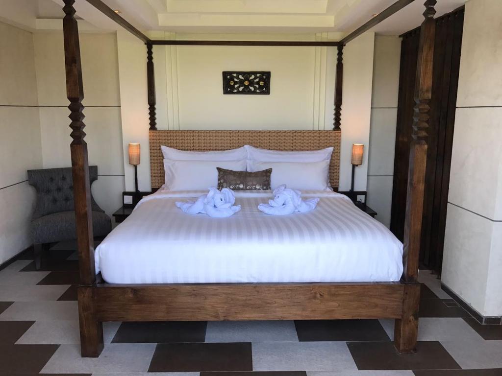 Postel nebo postele na pokoji v ubytování Anshel Hotel Seminyak