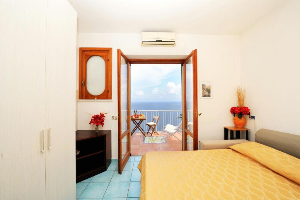 a bedroom with a bed and a view of the ocean at Amalfi Super Panoramico in Amalfi
