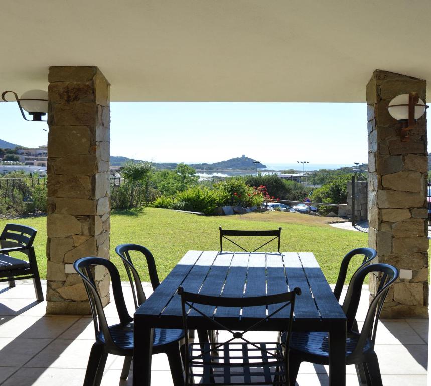 a blue table and chairs on a patio at Sa Tirìa in Chia