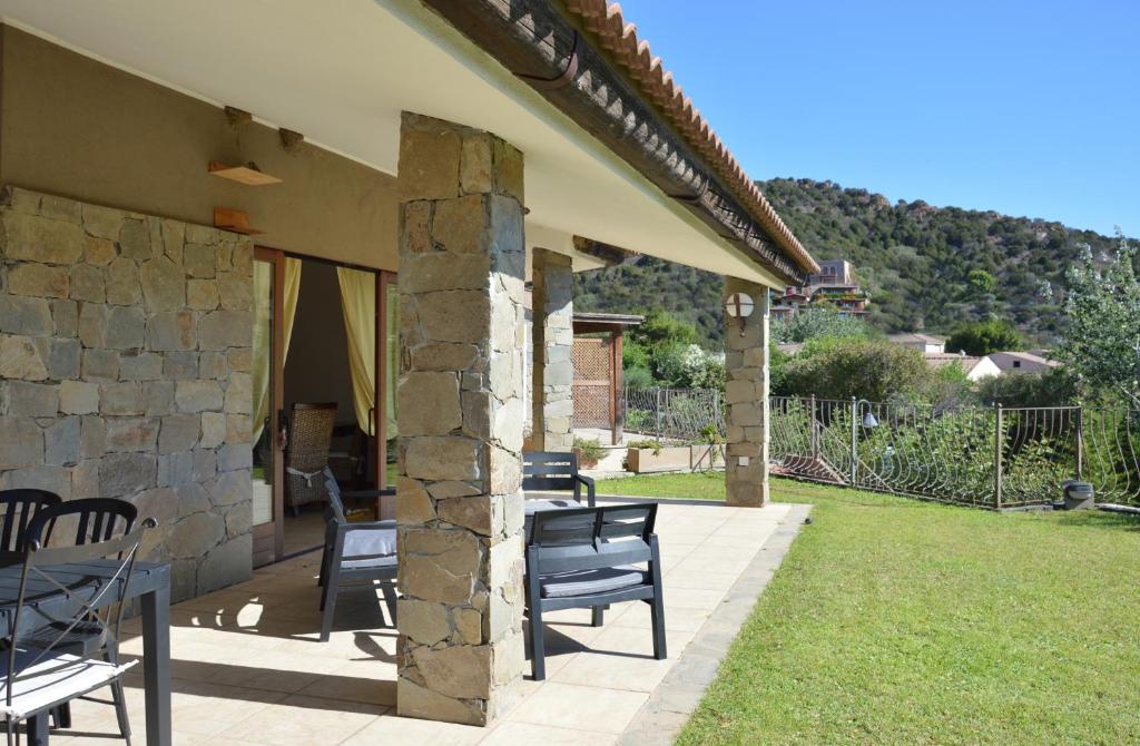 a patio of a house with chairs on it at Sa Tirìa in Chia