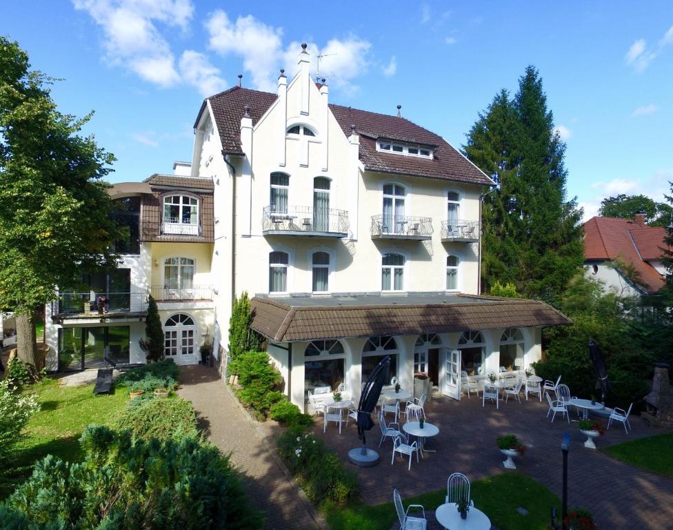 an aerial view of a large white house with tables and chairs at Seeresidenz Gesundbrunn in Plau am See