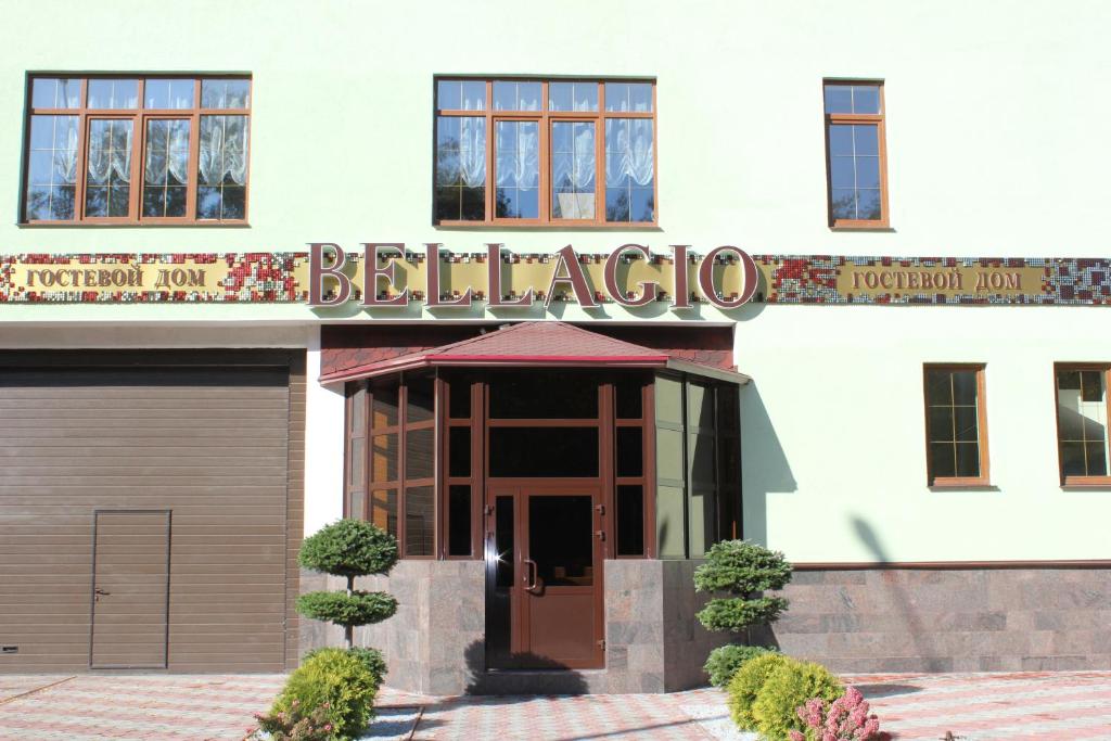 a building with a sign for the entrance to a restaurant at Guest House Bellagio in Tolyatti