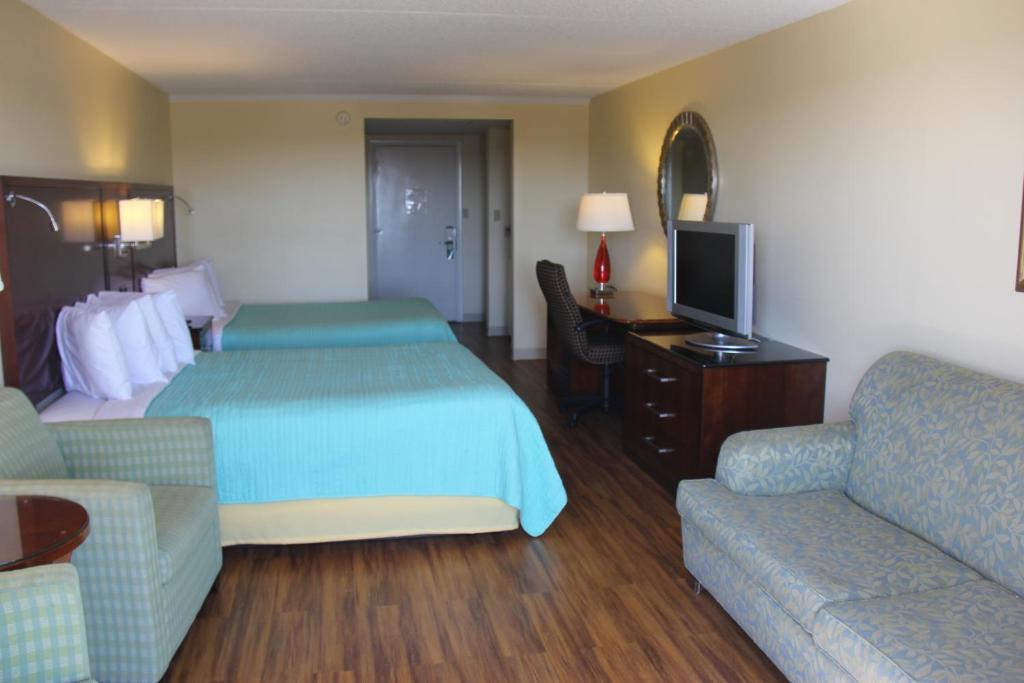 Postel nebo postele na pokoji v ubytování Seaside Inn & Suites