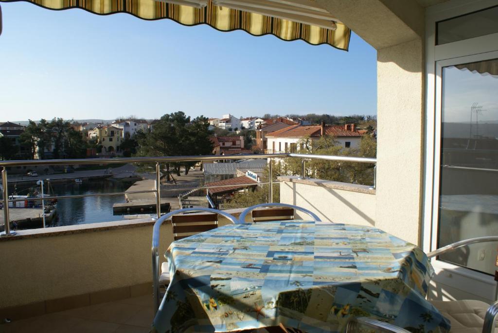 a table and chairs on a balcony with a view at Apartments Robert in Porat