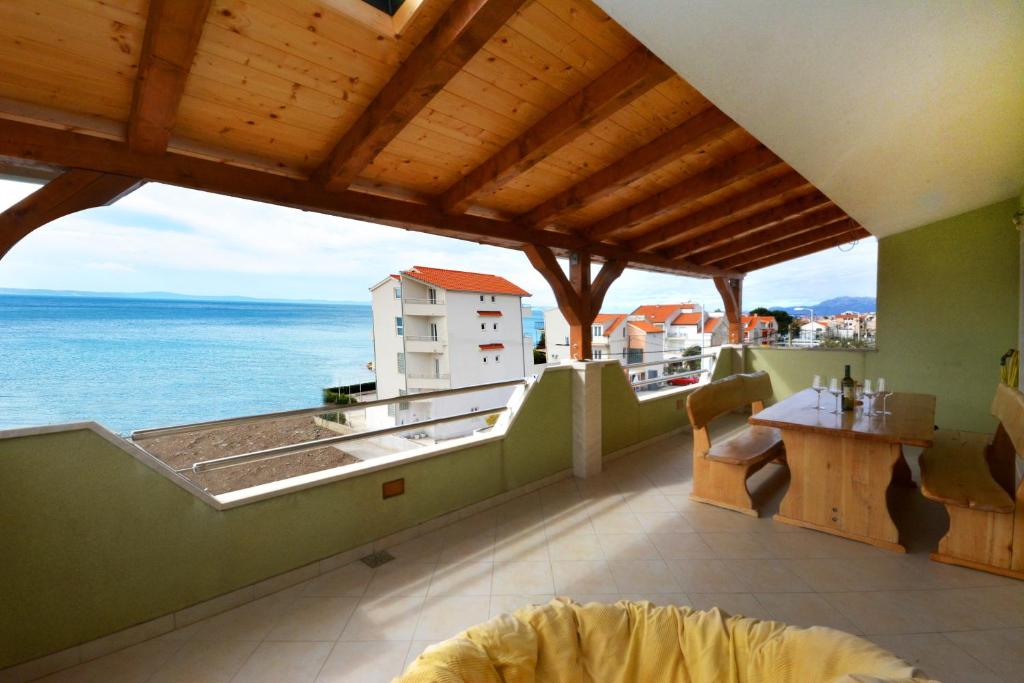 a balcony with a view of the ocean at Beach Apartman Petra in Podstrana