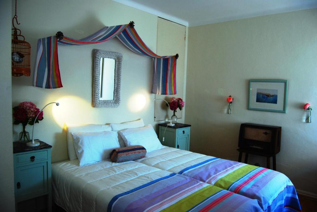 a bedroom with a bed with a suitcase on it at Casa Maria Obidos in Óbidos