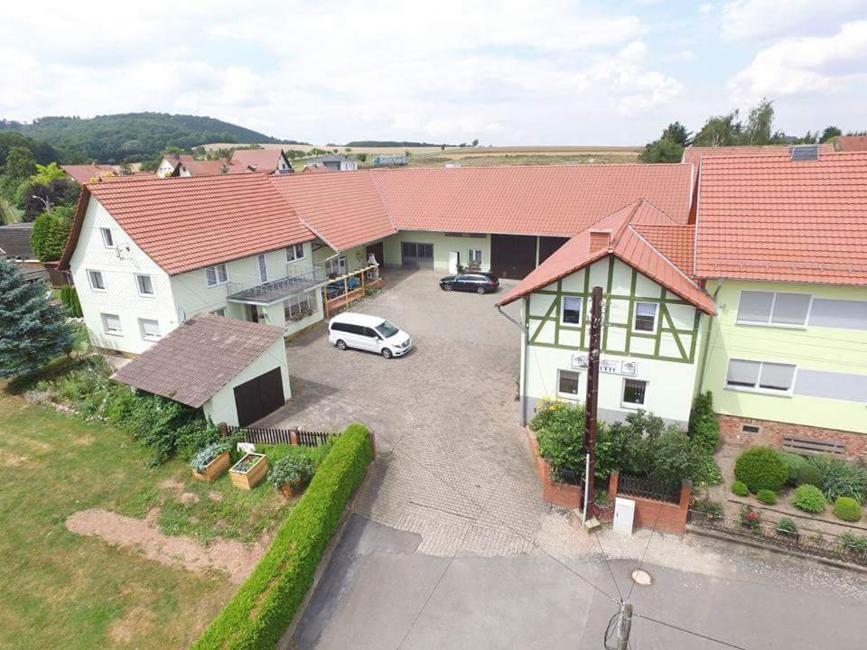 an aerial view of a house with a car parked in a driveway at landpension-dette in Berlingerode